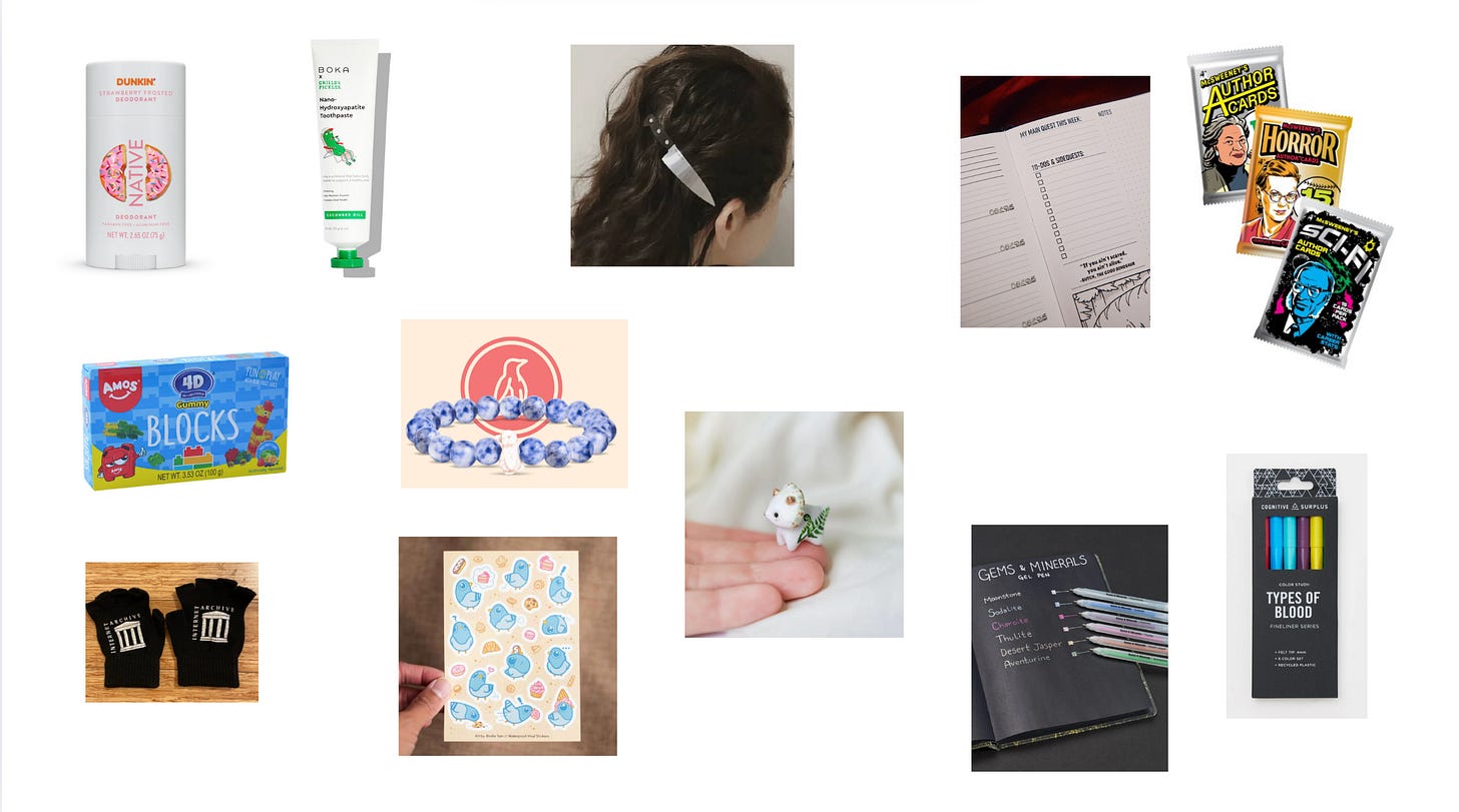 collage of the various stocking stuffers mentioned below. Clockwise is the strawberry frosted Native Dunkin deodorant, Grillo’s pickle toothpaste with a pillow in sunglasses relaxing in a lounge chair on the bottle, a picture of the back of a woman’s head with a giant knife barrette that looks like it’s about to go into her skull, one page of a planner that has sections for a main quest and side quests, a three pack of McSweeney’s author cards (one unlabaled, one Horror, one Scifi), a pack of multicolored pens labeled types of blood, a picture of a notebook with black paper open to demonstrate how the gems and minerals gel pen set looks on its pages, a tiny ceramic triceratops with a delicate fern design painted on it held in someone’s hand, a sheet of stickers featuring adorable fat blue pigeons scattered with cupcakes, eclairs and other pastries, a beaded bracelet with a penguin or puffin icon set in the middle of the beads, a pair of black fingerless gloves with the Internet Archive logo on them, and a box of 4d gummy block candy that shows them stacked to make a giraffe.
