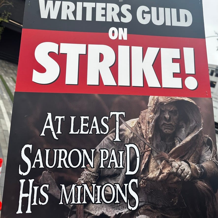 WGA strike sign that says "At least Sauron paid his minions"