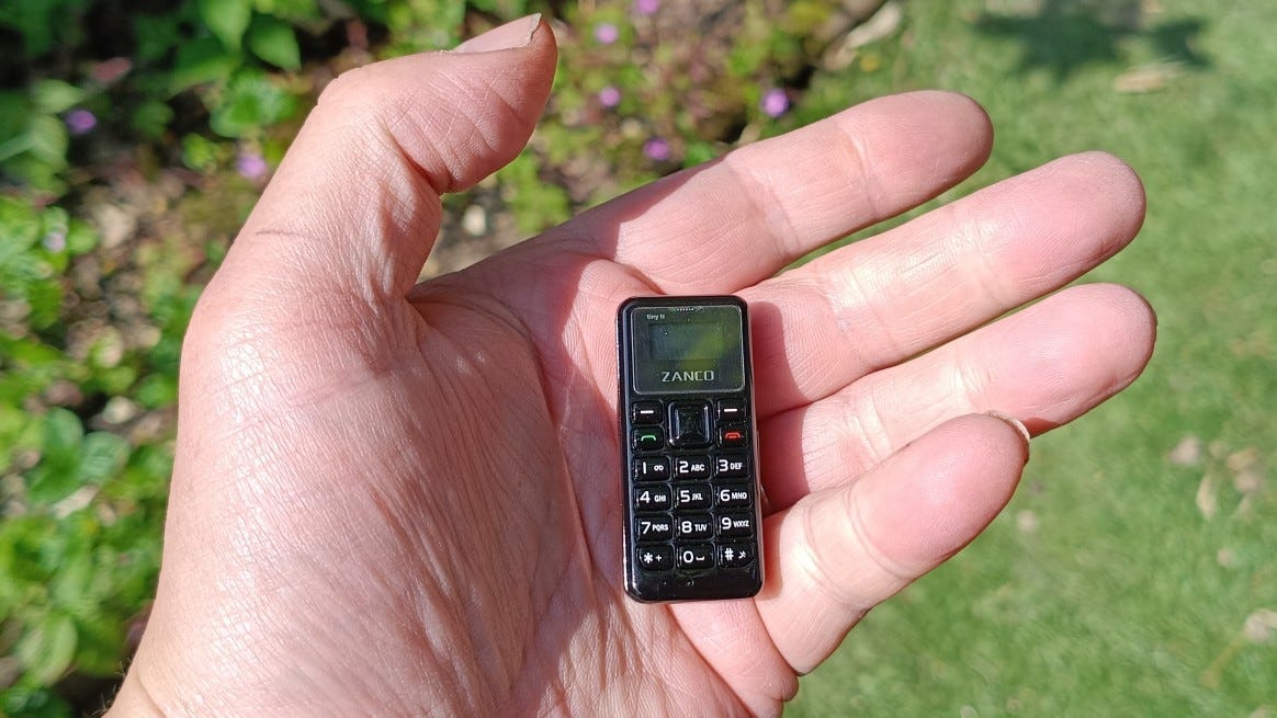 Zanco Tiny T1 miniature phone in a hand, example of extreme small-phone trend and reversal, used in pendulum effect investing essay. Zanco Tiny T1 miniature phone in a hand, example of extreme small-phone trend and reversal, used in pendulum effect investing essay.