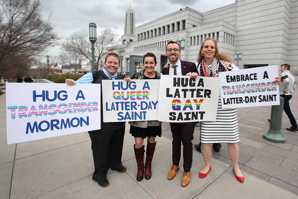 LGBTQ Mormon's pose for a picture and hold signs outside the Conference Center between sessions of the Church of Jesus Christ of Latter-Day Saints 189th Annual General conference of the church on April 6, 2019 in Salt Lake City, Utah.