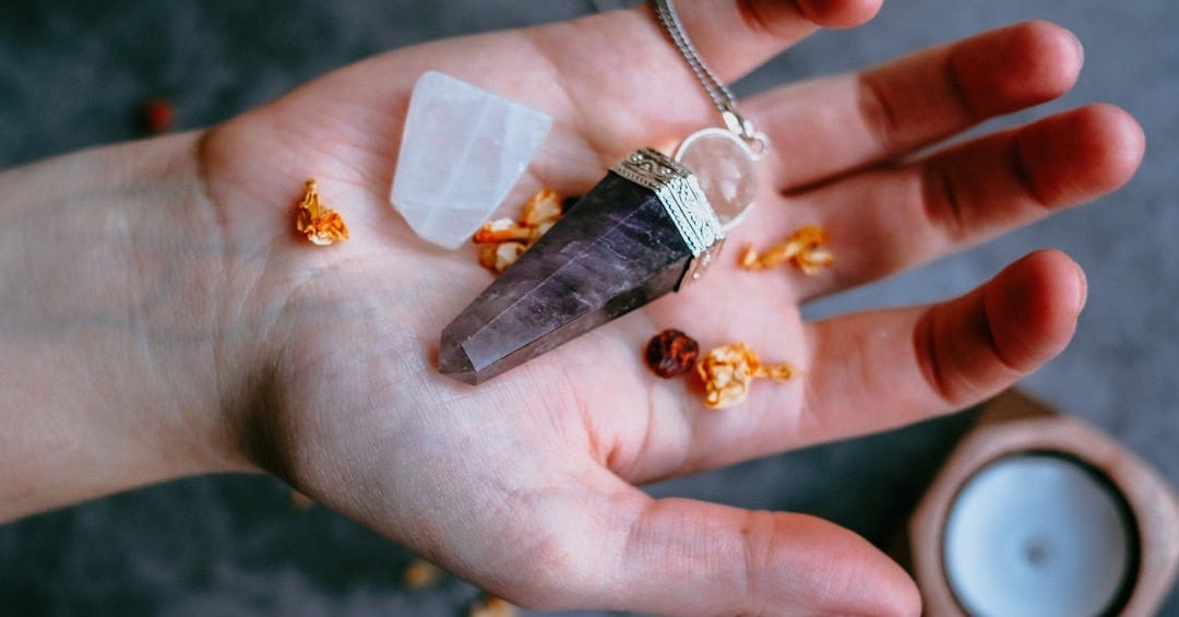 black pendant on palm