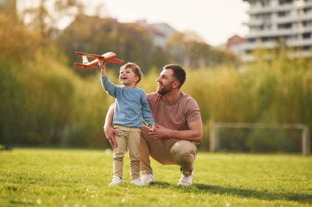 Weekend activities. Playing with toy plane. Happy father with son are having fun on the field at summertime Weekend activities. Playing with toy plane. Happy father with son are having fun on the field at summertime. children stock pictures, royalty-free photos & images