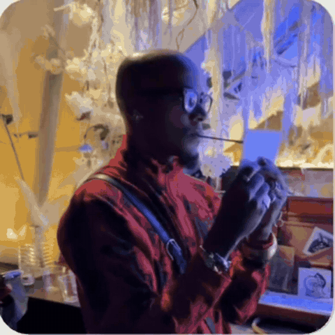 Dig Ferreira painting live at a show with the brush between his teeth — Doc-Drawing in motion.