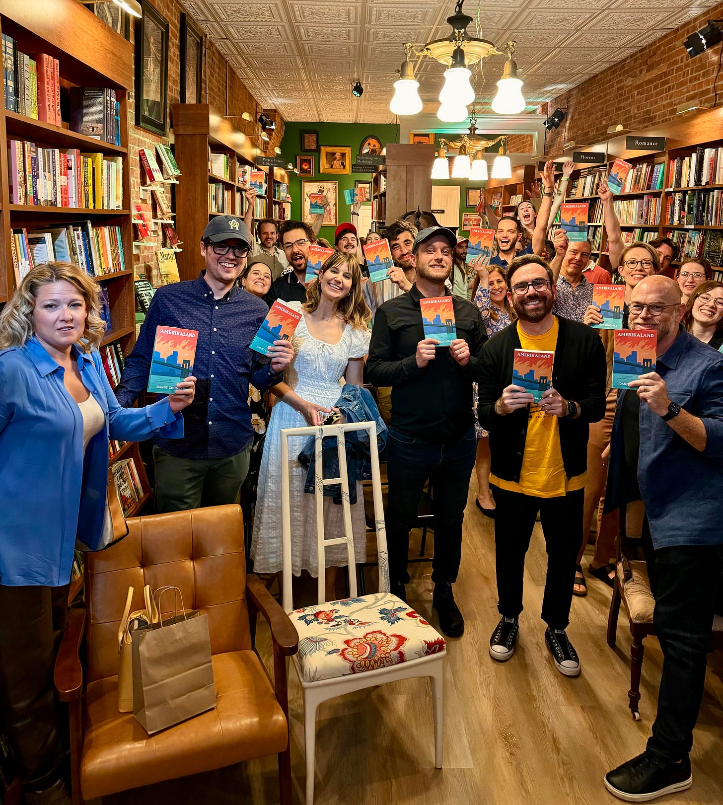 Friends and family gathered at Stanza Books in Beacon, NY for the AMERIKALAND book launch, proudly displaying their copies, smiling wonderfully for the camera.