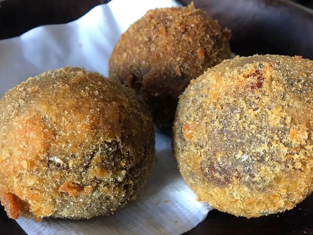 Three deep-fried feijoada balls