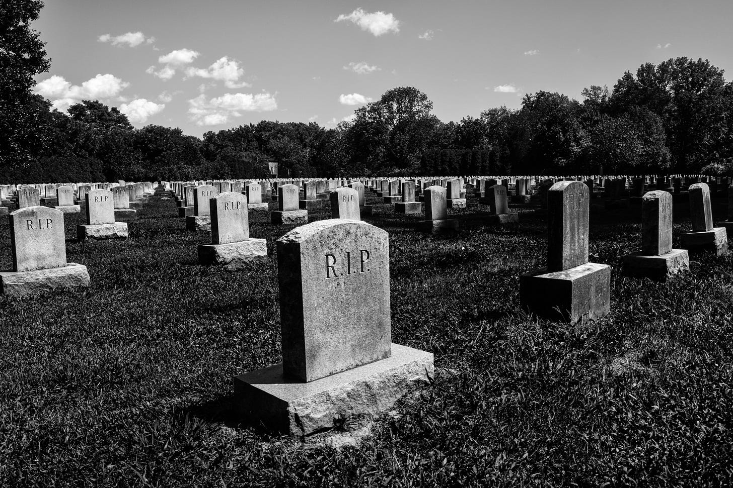 gravestone with rip on it in cemetery with other gravestones black and white photo gravestone with rip on it in cemetery with other gravestones black and white photo