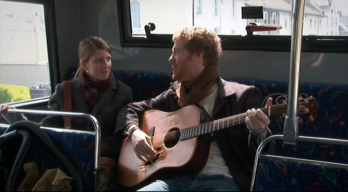 Still from Once where Marketa Irglova and Glen Hansard are sitting on a bus