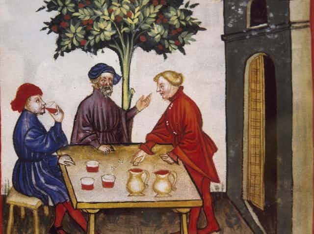 Three men drinking and chatting Three men drinking and chatting