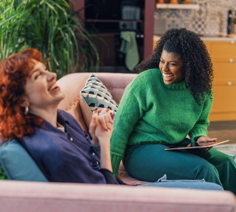 a woman and a man sitting on a couch a woman and a man sitting on a couch