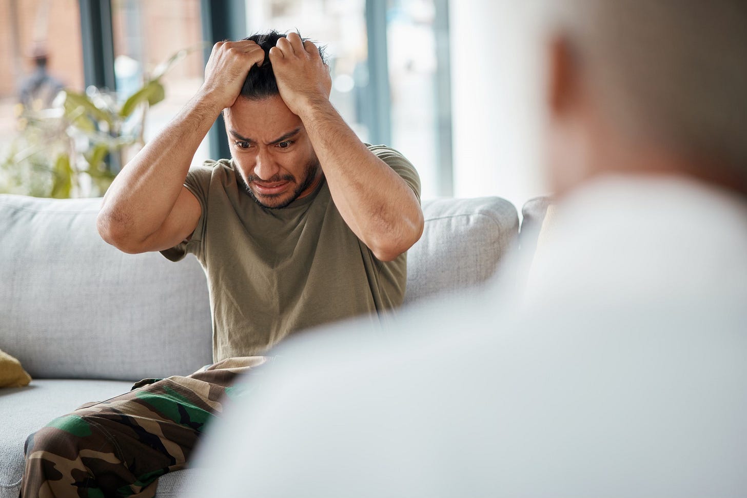 Army anger, ptsd and man in therapy with stress from war and a psychologist for support. Depression, thinking and military worker or soldier with anxiety in counseling with a healthcare professional
