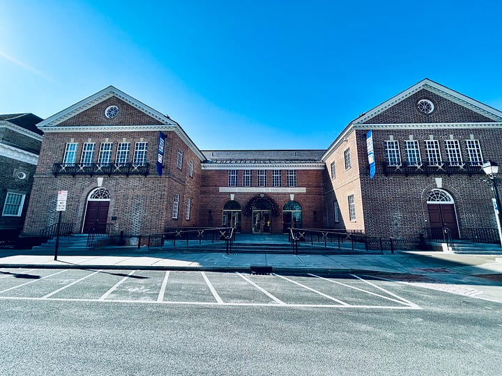 building, statues, doors, sky, street, pavement