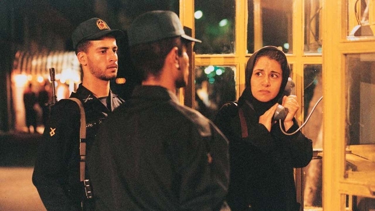 The Circle | Still features a young woman at a phone booth being interrupted by authorities.