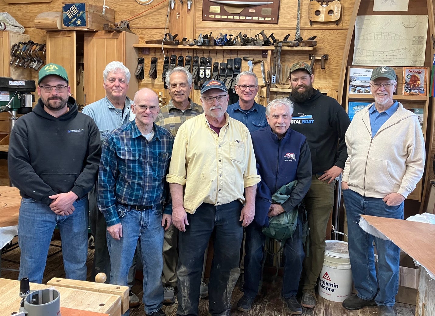 A group of men standing in a workshop

AI-generated content may be incorrect.