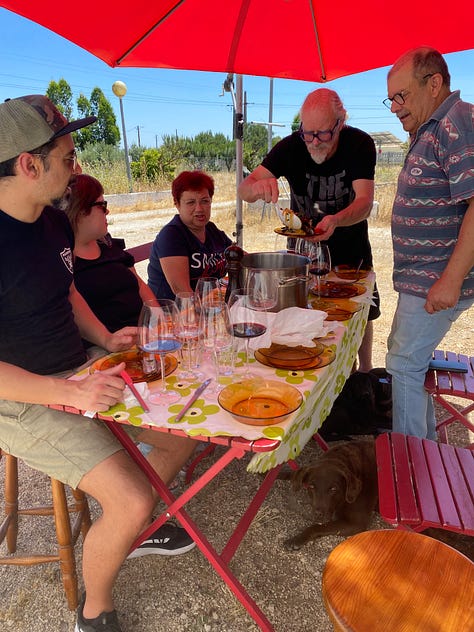 People cooking food, sharing a meal and playing musical instruments