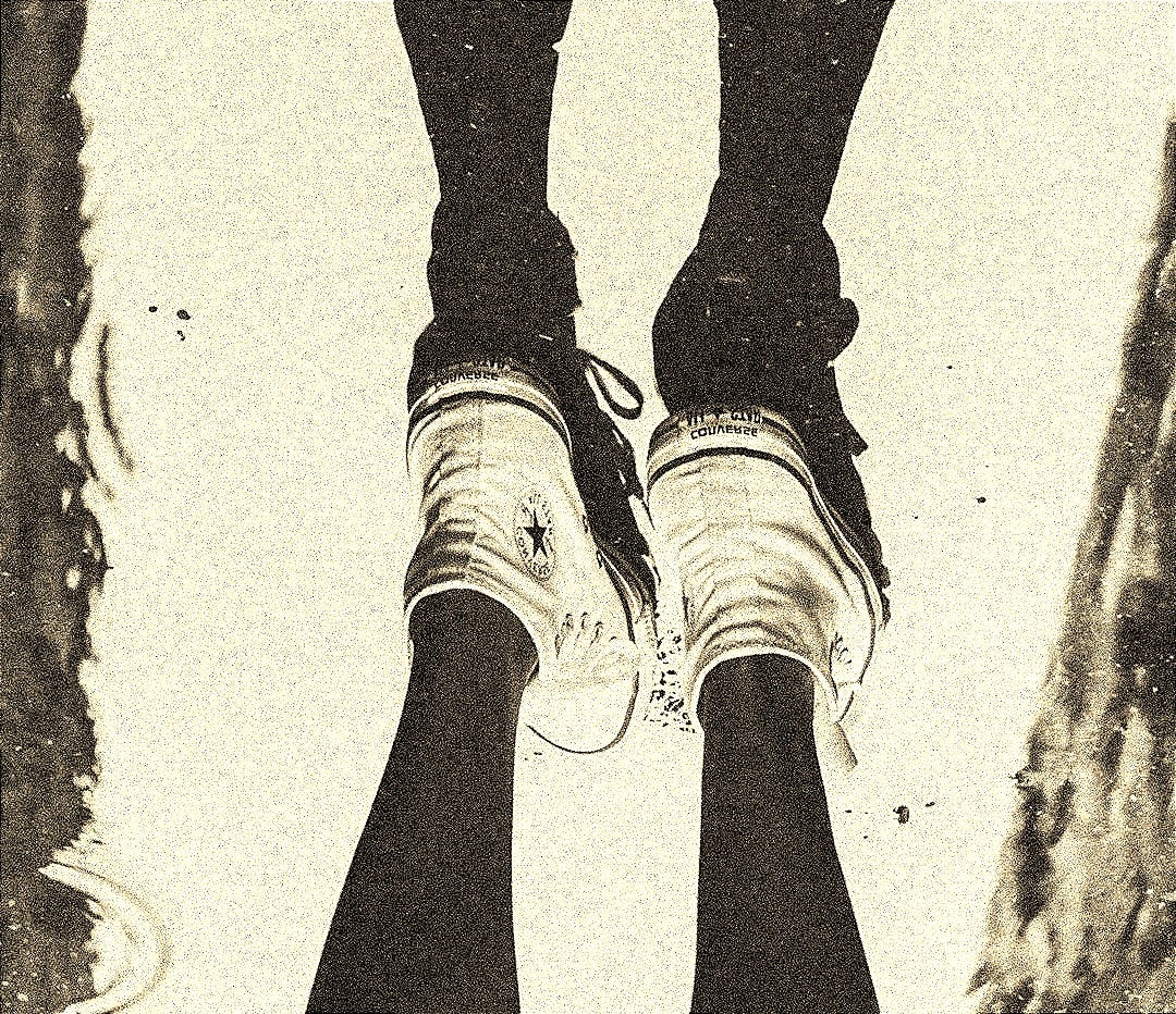 a person standing in a puddle with their feet in the water