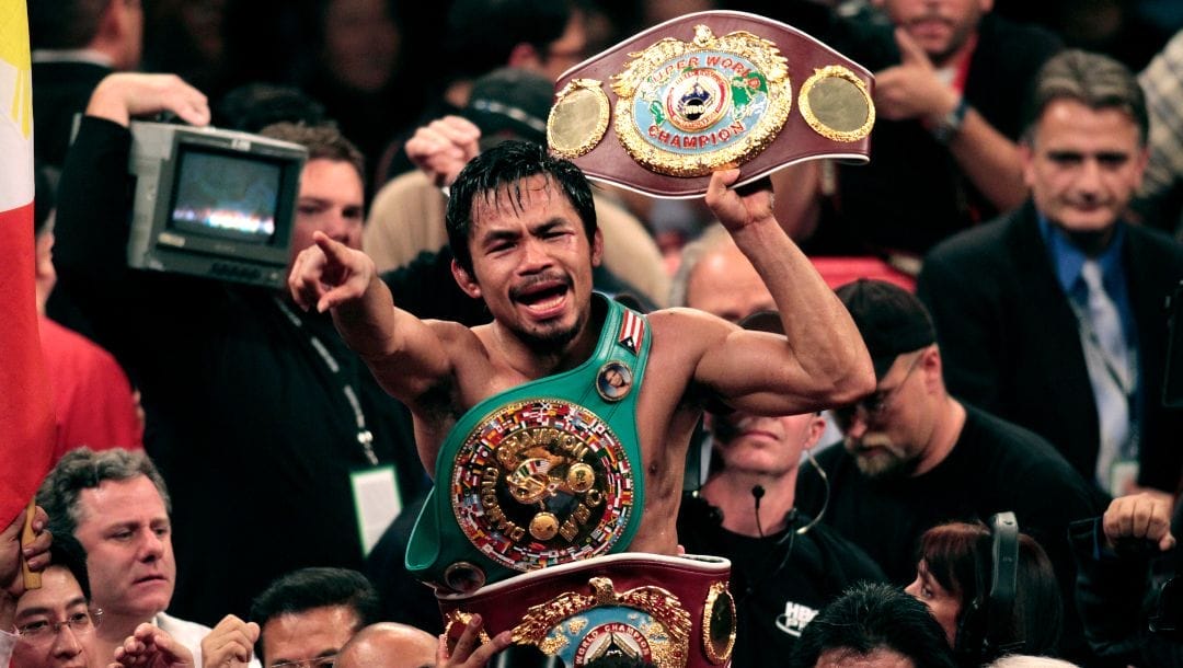 Manny Pacquiao, of the Philippines, holds the championship belt at the finish of his WBO welterweight boxing title fight. Manny Pacquiao, of the Philippines, holds the championship belt at the finish of his WBO welterweight boxing title fight.