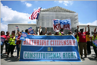 A group of people holding signs

AI-generated content may be incorrect.