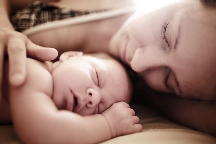 A newborn baby with its mother. A newborn baby with its mother.