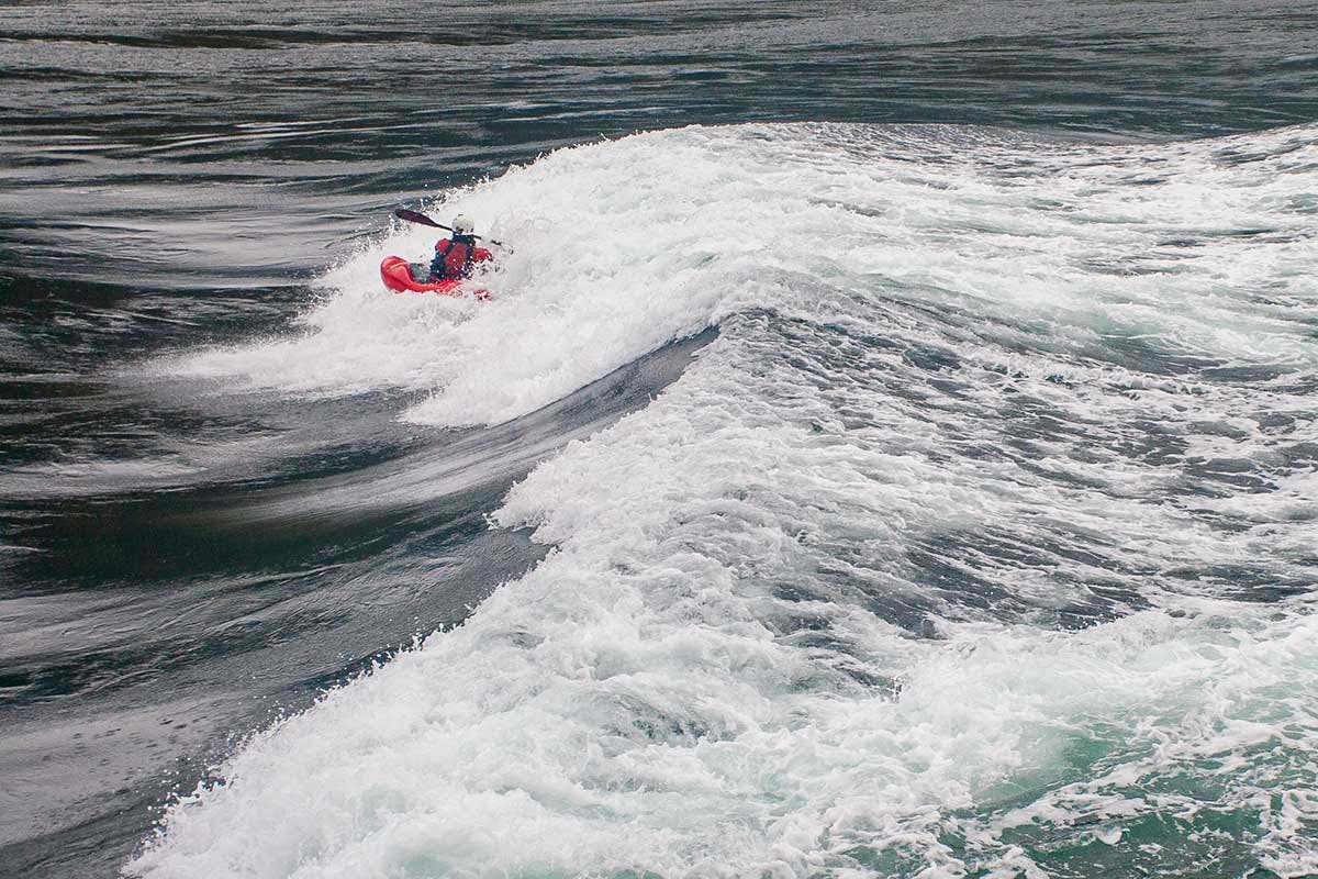 kayaker in all red plays in the whitewater of Skookumchuck Narrows