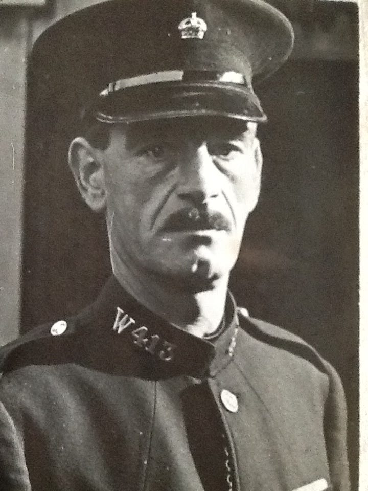 An officer in uniform with W in his collar number, signifying he is a war reserve.