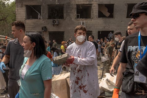 (1) An emergency worker helping in the evacuation of Vovchansk sits behind the steering wheel of a vehicle in May. Vovchansk was heavily shelled by Russian artillery whose forces crossed into Ukraine in what is reported to be an attempt to create a new front as part of their summer offensive. Simon Townsley—Panos Pictures. (2) Injured Russian soldiers at a hospital underground in Bakhmut, on Jan. 22. Nanna Heitmann—Magnum Photos. (3) Volunteers, including medics, help emergency and rescue personnel clear the rubble of a destroyed building at Ohmatdyt Children's Hospital following a Russian missile attack in Kyiv on July 8.Roman Pilipey—AFP/Getty Images.