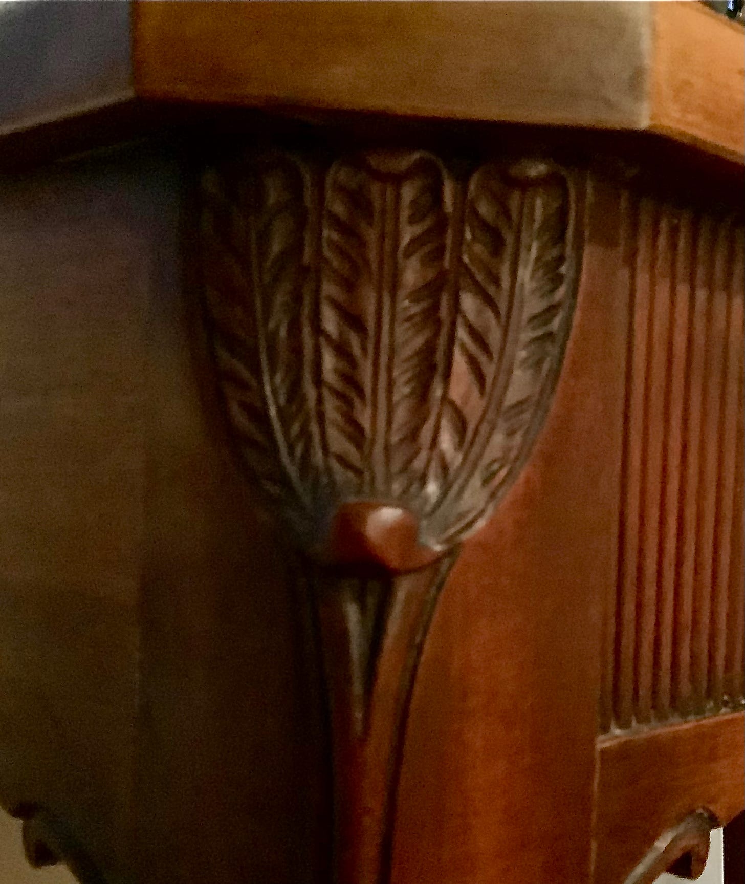 Lovely carved leaf details and fluting int he wood of Minnie's dining room table.