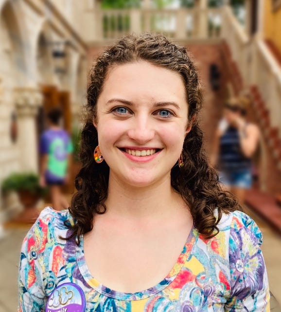 A person smiling at camera

Description automatically generated