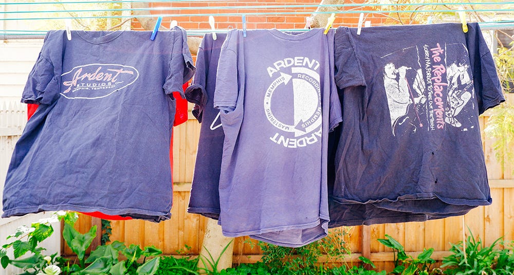 two ardent tshirts and one replacements t-shirt on a clothes line