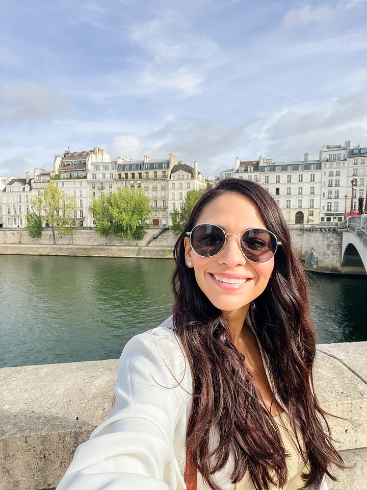 Counter-clockwise from top left: woman sitting at a chair reading aloud from a laptop; selfie photo of woman with Shakespeare and Company bookstore in background; selfie photo of woman with the river Seine and row of Hausmann-style Parisian buildings; selfie of woman with building number 59 behind her in Paris.