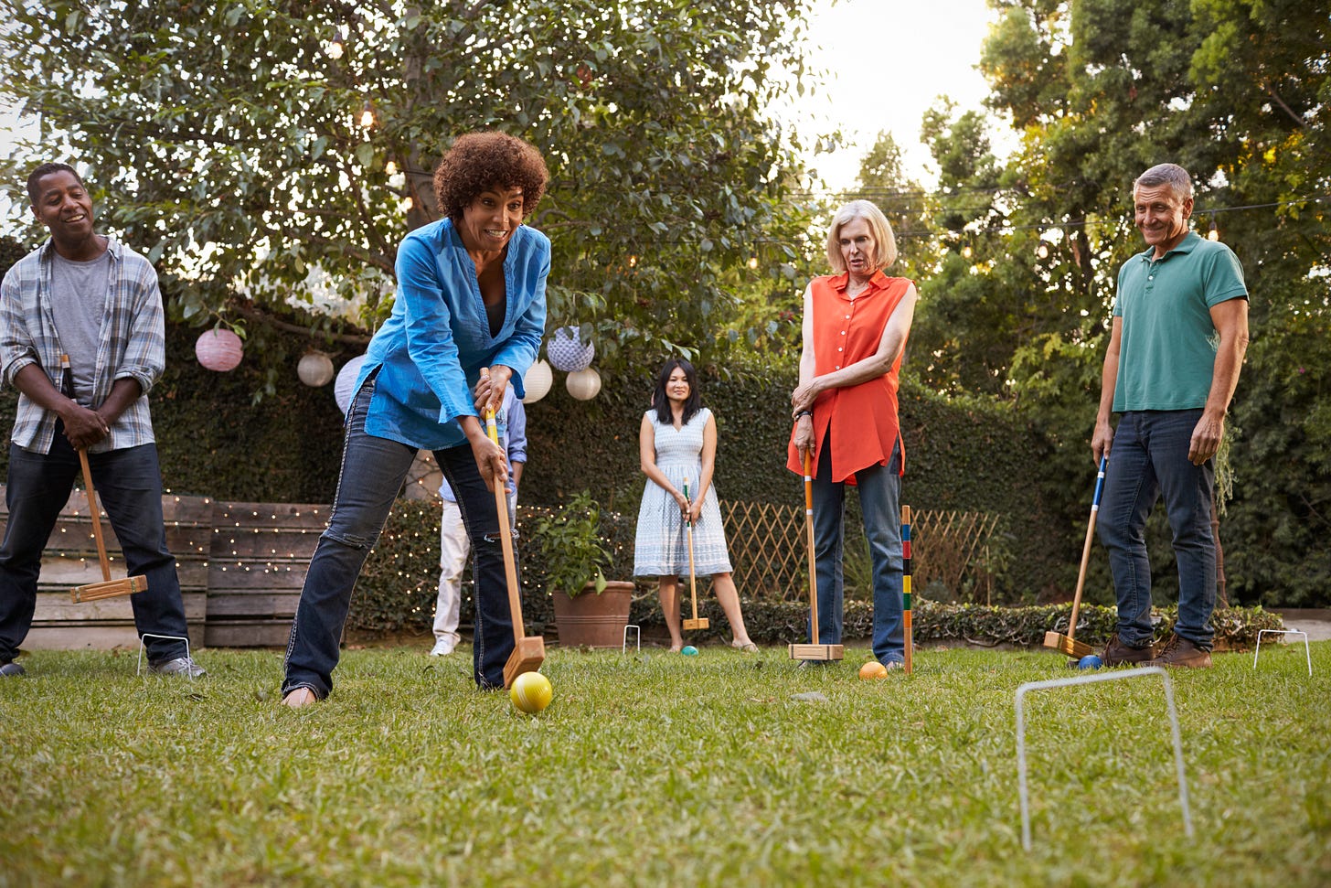 Group of adults playing croquet