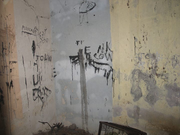 A series of images showing the air raid shelter pre-restoration. The walls are dirty and cobweb ridden, covered in graffiti and the floor is covered in rubble and dirt.
