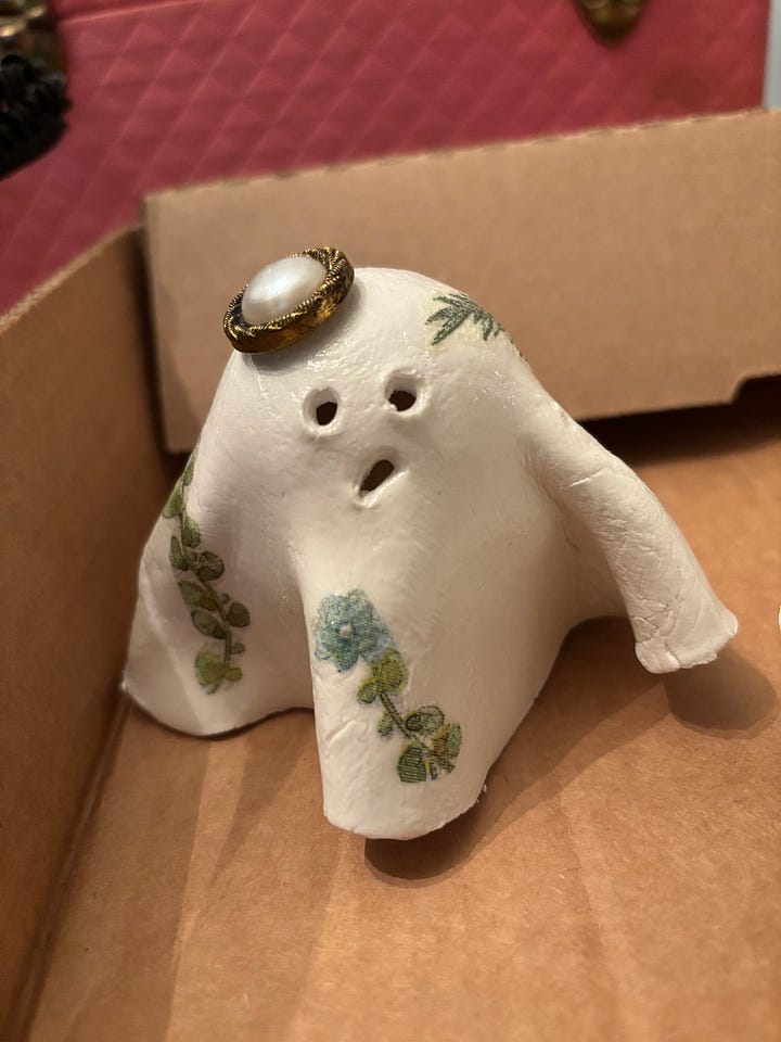 gallery of four clay ghosts decorated for Halloween