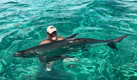 angler with large permit standing in the water