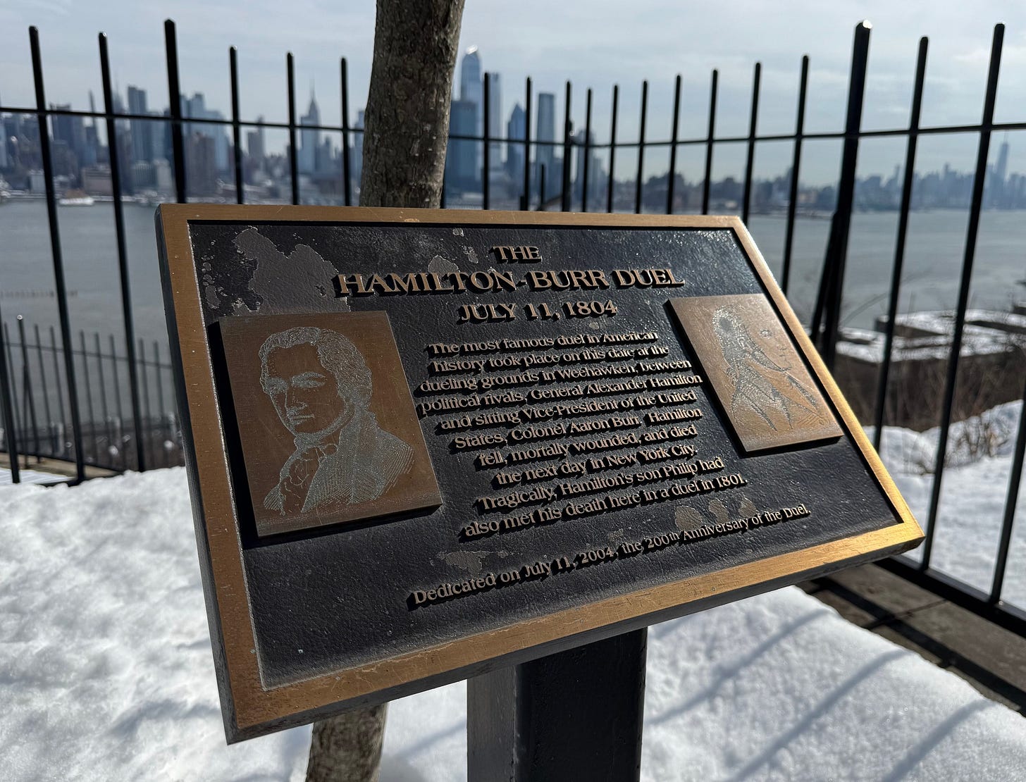 May be an image of the Statue of Liberty, the Queensboro Bridge and text