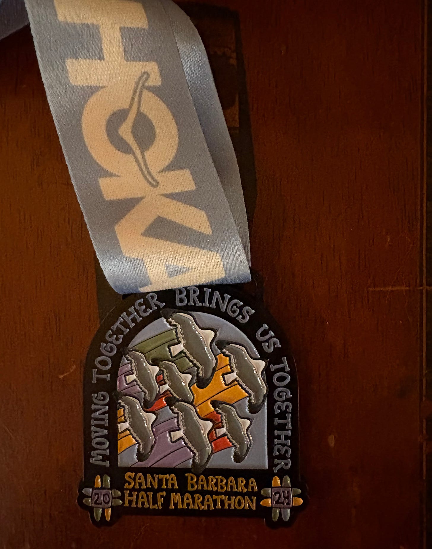 Finisher’s medal for the Santa Barbara Half Marathon and 5K.
