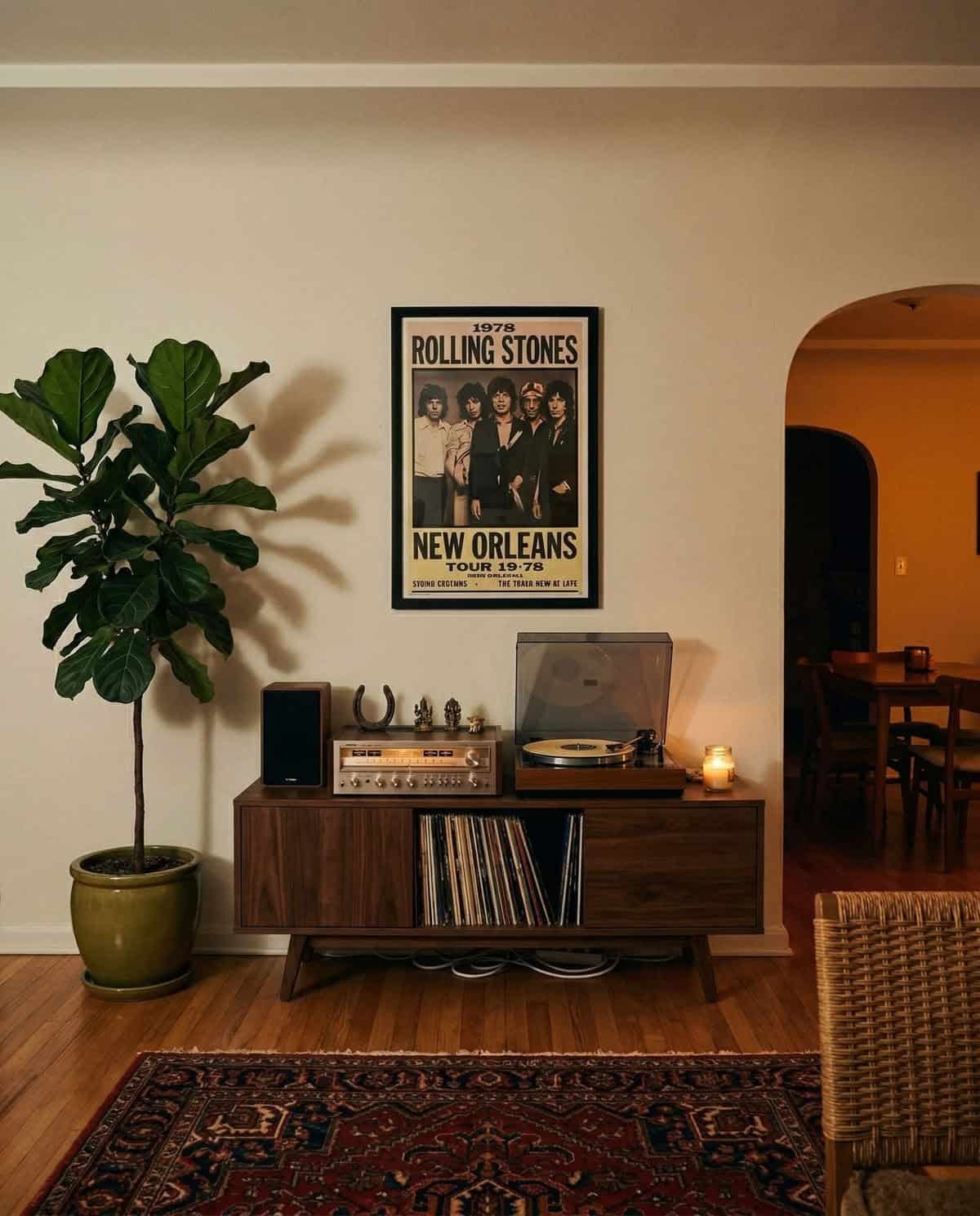 a fiddle leaf fig next to a record player and a poster of the Rolling Stones. a fiddle leaf fig next to a record player and a poster of the Rolling Stones.