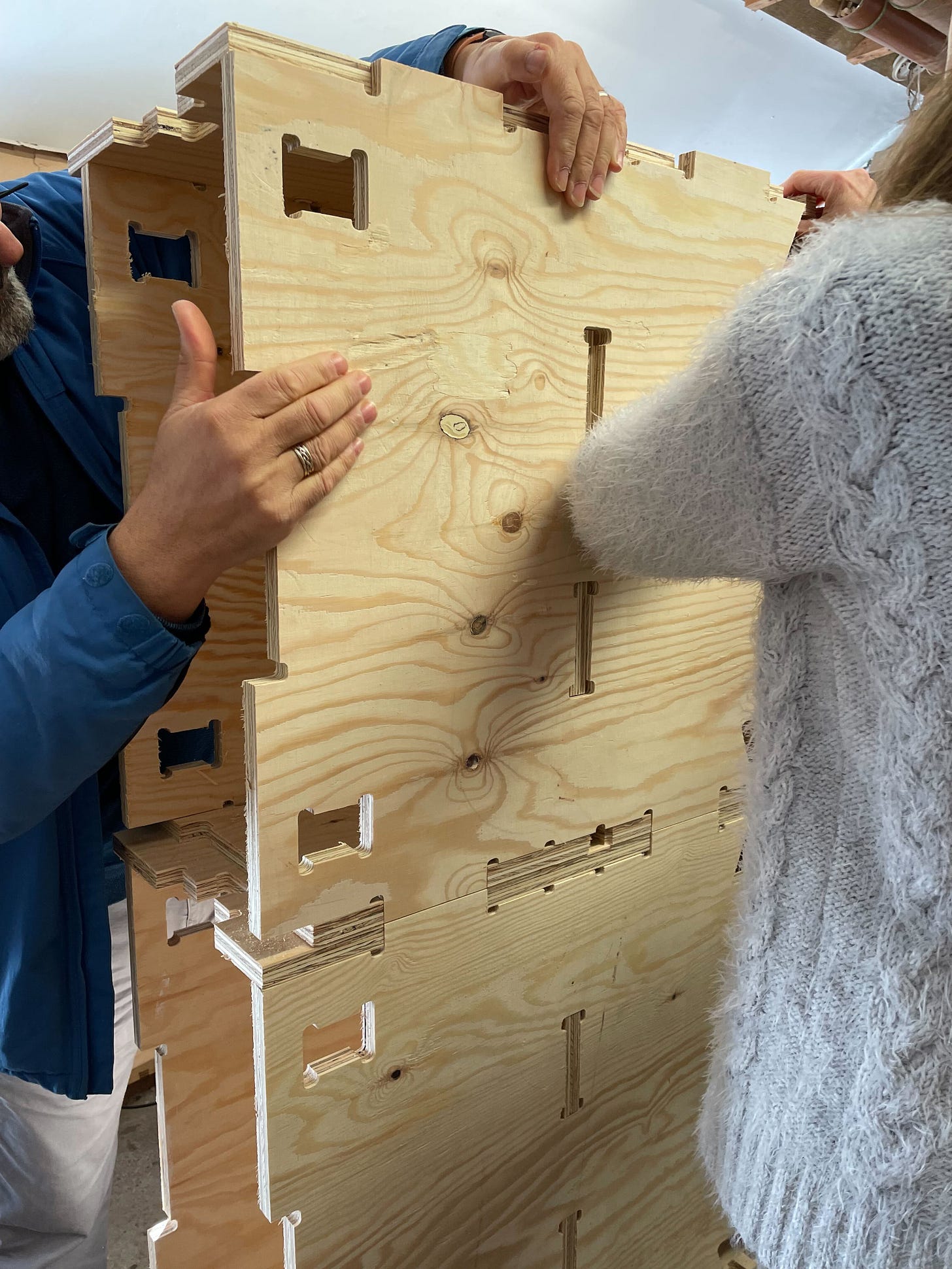 2 people assemble a WikiHouse Skylark timber block