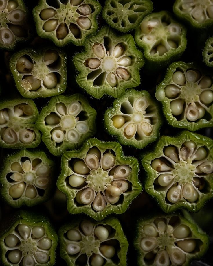 This may contain: close up view of the inside of a green plant with many seeds and leaves on it
