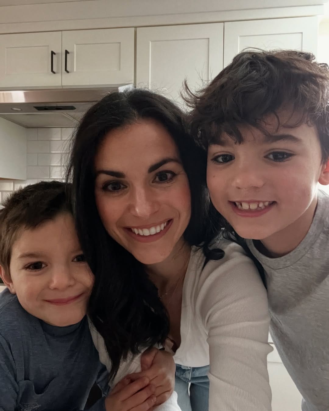 Alina Mauritz & her sons 6 and 9, smiling for a picture