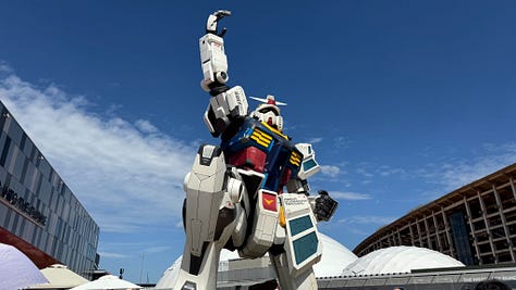 A collage of six photos from the Osaka World Expo 2025. Top left: a giant white Gundam robot statue set against a blue sky. Top middle: people exploring a dimly lit exhibit with a statue in traditional Southeast Asian attire and rice stalks on display. Top right: performers dressed in colorful cultural costumes on an outdoor stage with a bright patterned backdrop. Bottom left: a vast wooden pavilion with tall beams and people walking through. Bottom middle: an illuminated modern installation at night featuring mirrored structures with glowing circular displays. Bottom right: a wide view over the expo grounds at sunset, showing pavilions, pathways, and visitors.