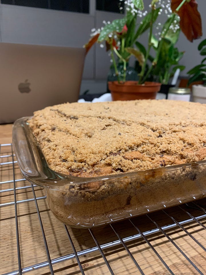 A glass pan of coffee cake cooling on a wire rack (left). A slice of coffee cake on a blue plate and with a bite taken out (sorry!) (right).