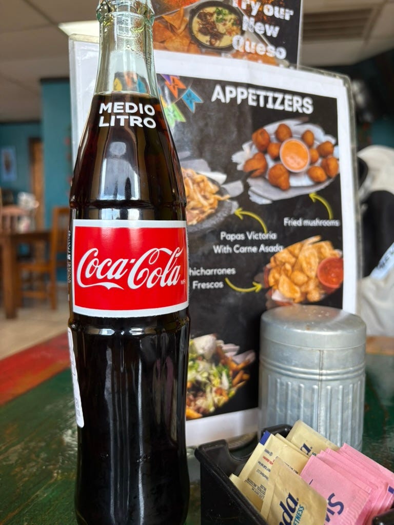 Medio Litro Coke on a table with a menu
