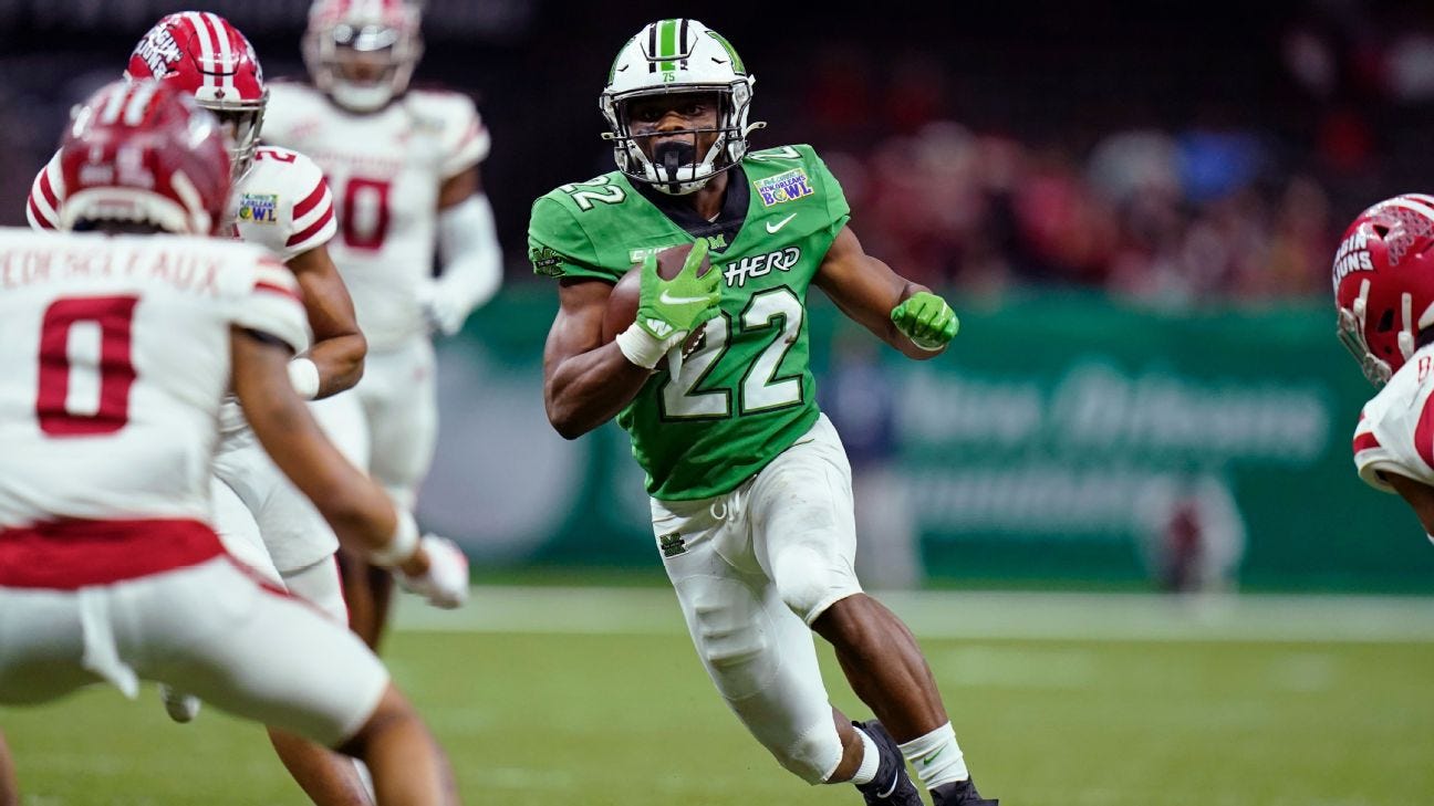 Marshall RB Rasheen Ali looks to evade defenders after getting the hand off.