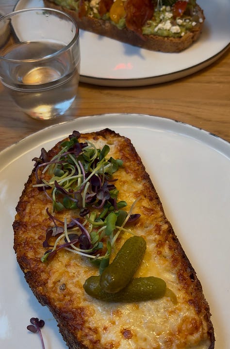 A plate of grilled cheese, plates on a restaurant table