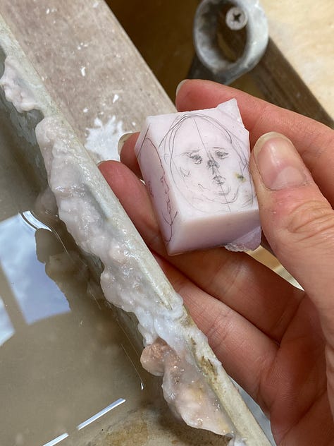 man carved out of pink opal