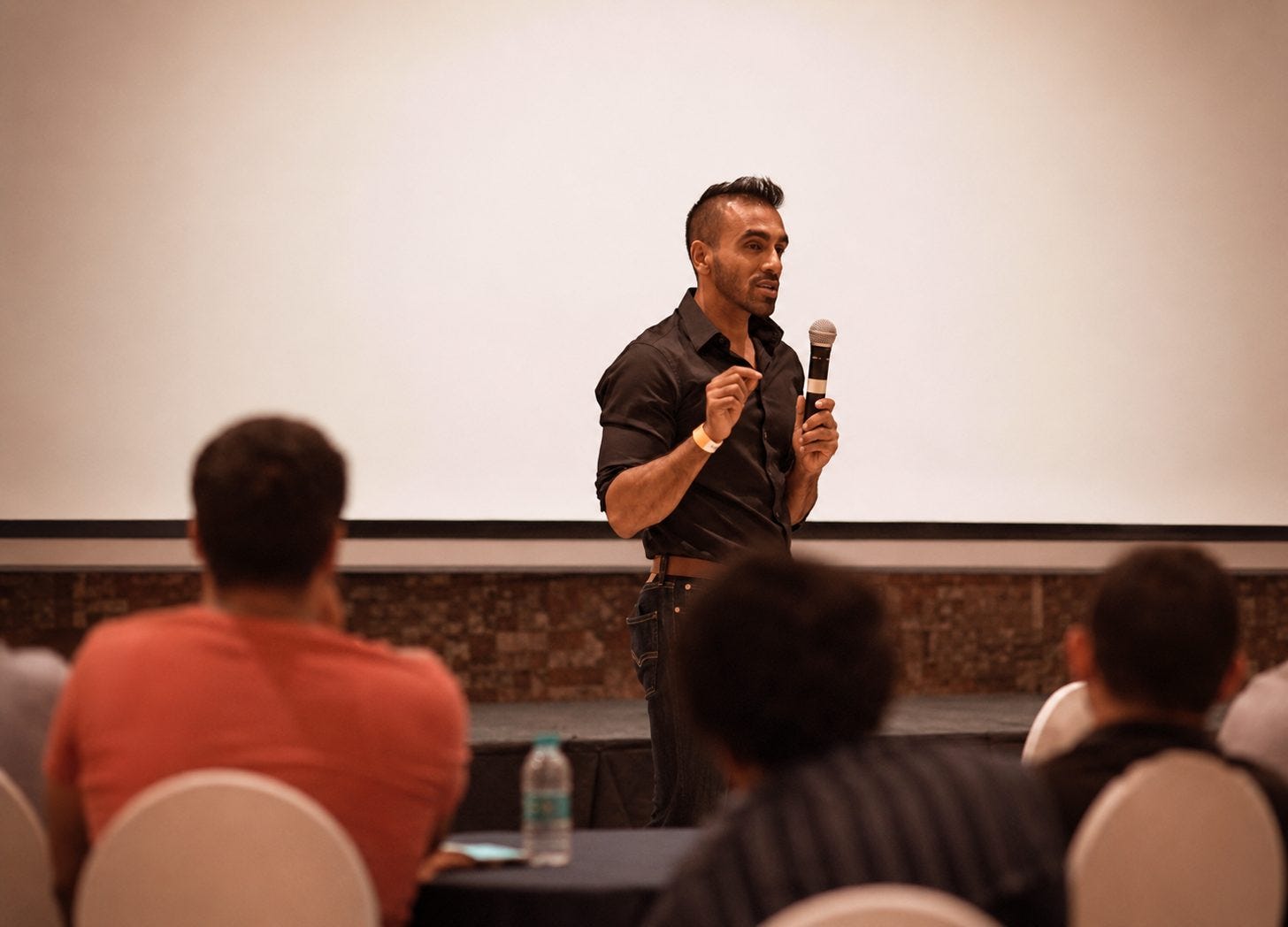 Abhishek (Avi) Agarwal speaking on stage with a microphone Abhishek (Avi) Agarwal speaking on stage with a microphone