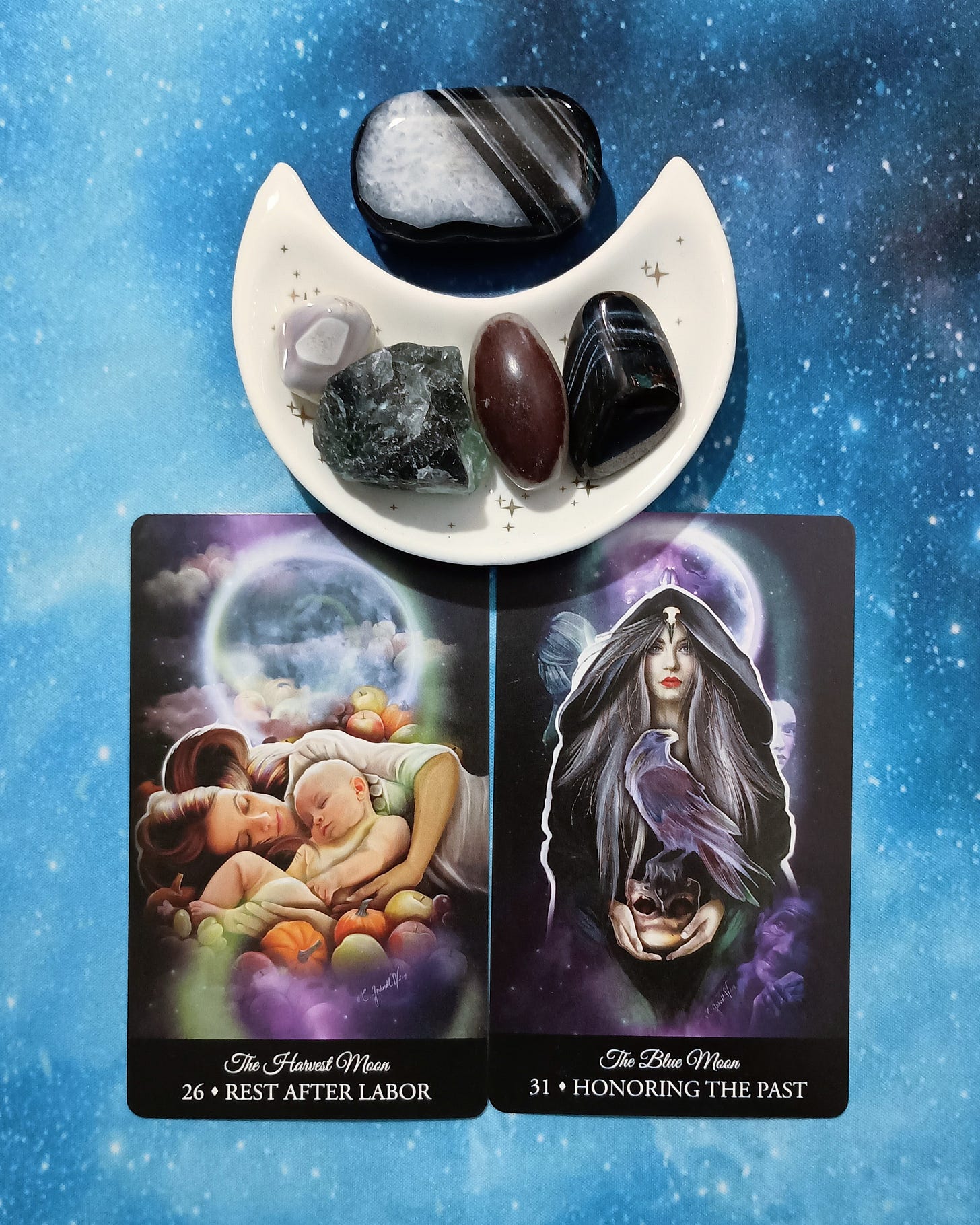 Rest, Honor, & Heal: A Message From the Universe, 2 Witching Hour Oracle cards and crystals on a starry blue background