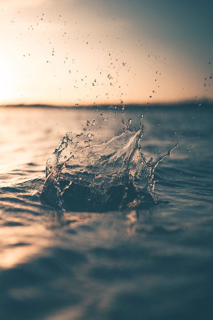 A splash of water in a lake at twilight. A splash of water in a lake at twilight.