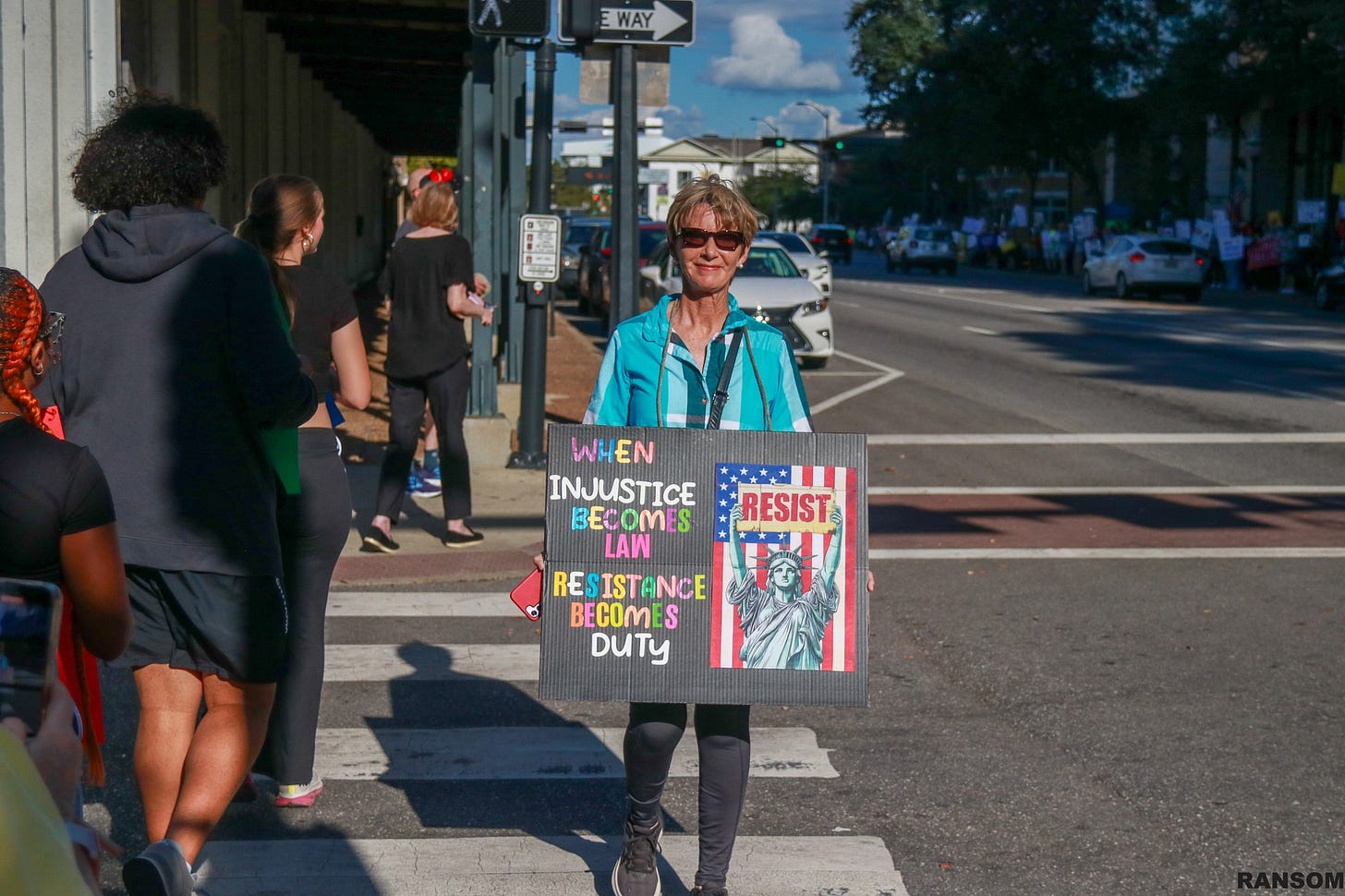 May be an image of crowd, street and text