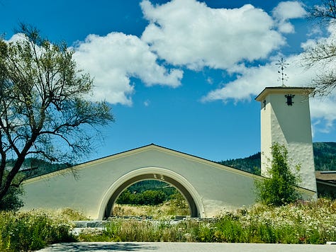 The restored iconic tower at Robert Mondavi Winery against a blue sky, Napa Valley The courtyard garden at Robert Mondavi Winery looking out to the vineyard and Napa Valley mountains The wide interior bar at Robert Mondavi Winery, wood ceiling, floor-to-ceiling windows looking out to the valley The citrus salad course at The Mondavi Table, butter lettuce, castelvetrano olives, pistachios, citrus vinaigrette Robert Mondavi Winery stone entrance sign with wildflowers, Oakville, Napa Valley Handmade ricotta capelletti with Genovese pesto, English peas, and pecorino romano at The Mondavi Table The Napa River viewed from the third floor patio at River Terrace Inn, downtown Napa The vaulted stone cave at Inglenook, crystal chandelier over a long wooden table, Rutherford, Napa Valley The grand staircase at Inglenook château, red carpet and stained glass, unchanged since 1879